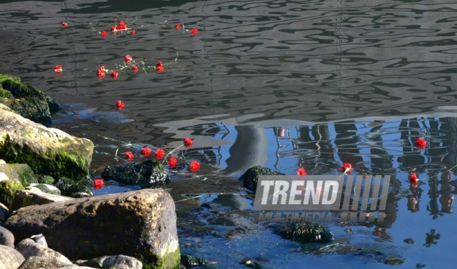 Baku residents bringing flowers to Seaside Boulevard to honor missing oil workers.  Azerbaijan, Dec.07, 2015